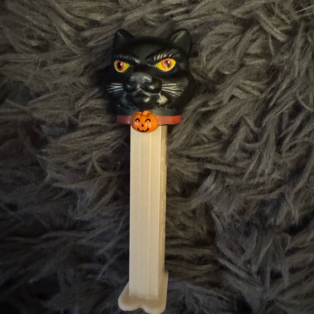 Black Cat Pez Dispenser with Pumpkin Collar, notable for its